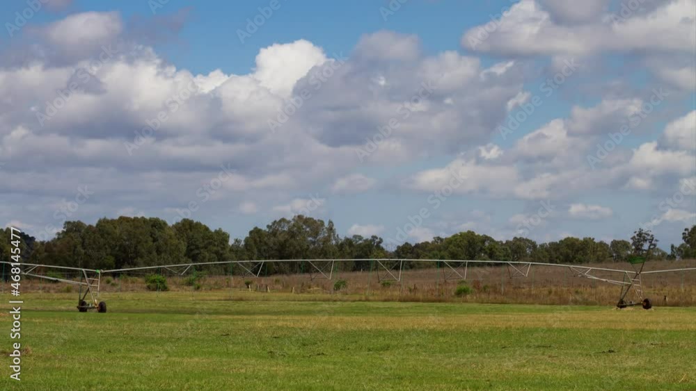 Time lapse Clouds over green grass and a centre pivot sprayer Time lapse Clouds over green grass and a centre pivot sprayer