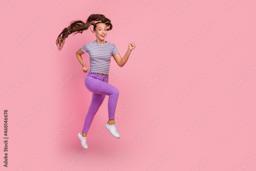 Full length body size view of attractive cheerful thin motivated girl jumping running isolated over pink color background Full length body size view of attractive cheerful thin motivated girl jumping running isolated over pink color background