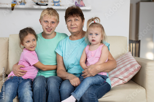 Grandmother sits with grandchildren