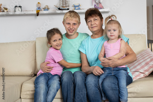 Grandmother sits with grandchildren © Evgenia Tiplyashina