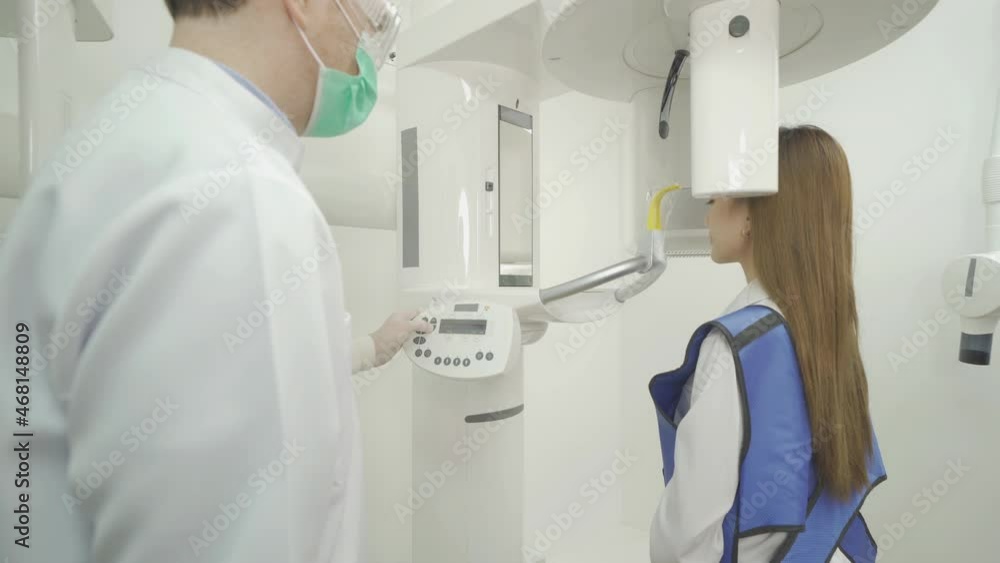 A caucasian dentist man, people having dental X-Ray on machine technology device to patient woman in lab. Teeth examine. Doctor. Dentistry, medical and dental health scan test. A caucasian dentist man, people having dental X-Ray on machine technology device to patient woman in lab. Teeth examine. Doctor. Dentistry, medical and dental health scan test.