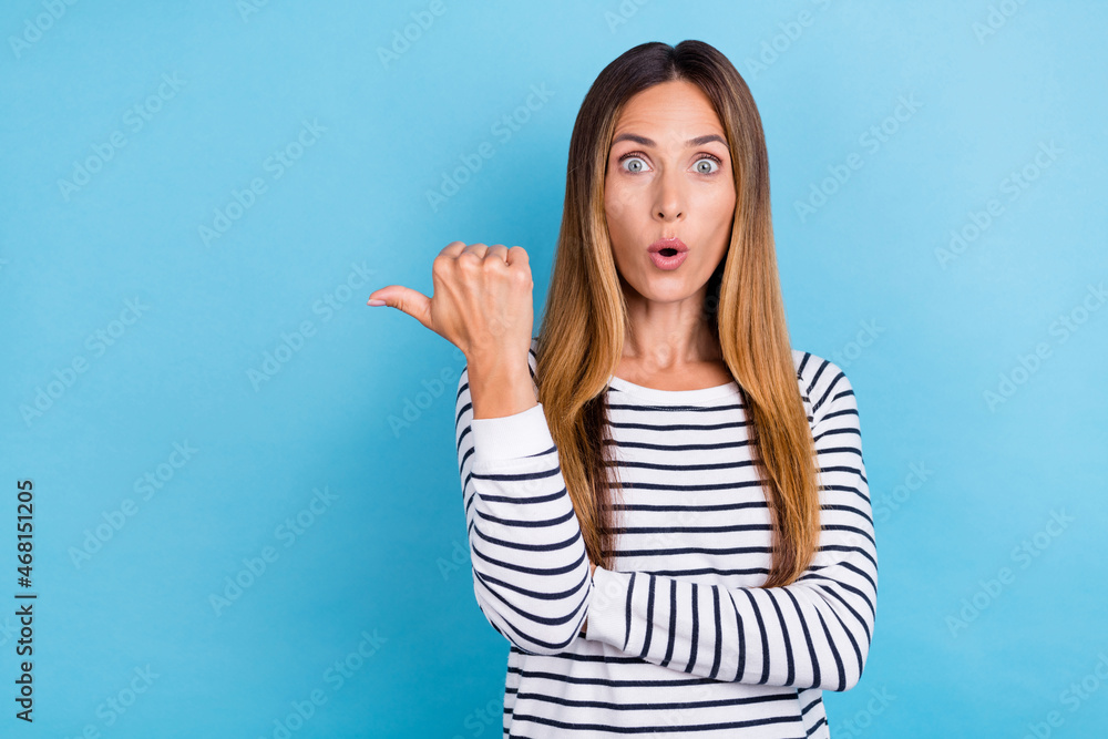Fototapeta premium Photo of young blond impressed lady point empty space wear white shirt isolated on blue color background