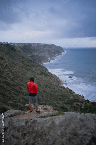 Male tourist admiring sea from cliff