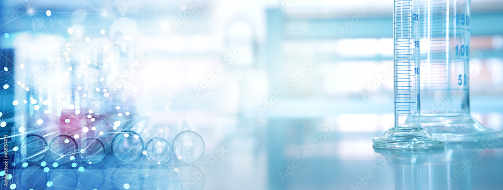 glass cylinder and test tube science equipment in blue research lab background glass cylinder and test tube science equipment in blue research lab background