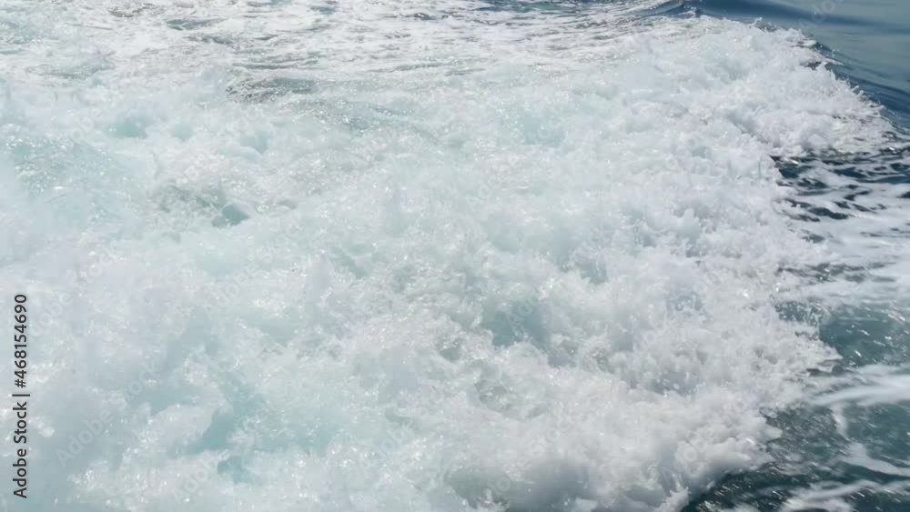 Sea waves with water foam after boat engine. Ocean splashing in motion closeup Sea waves with water foam after boat engine. Ocean splashing in motion closeup