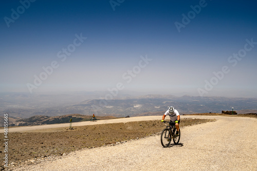 Fototapeta Naklejka Na Ścianę i Meble -  A man riding a bike in Sierra Nevada Mountains, Spain