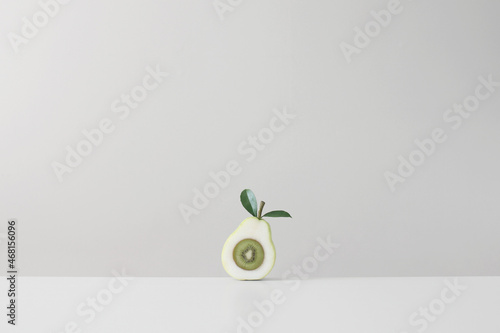 Kiwi fruit inside halved pear concept for things come in pairs photo