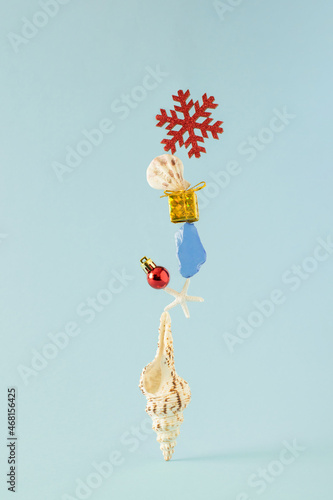 Creative composition of seashells and Christmas decoration. Minimal New year or Xmas beach convcept.