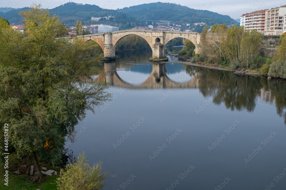 View of the Miño river and the Roman bridge in Ourense, Galicia. Spain.