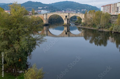 View of the Miño river and the Roman bridge in Ourense, Galicia. Spain.