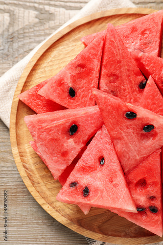 Delicious fresh watermelon slices on wooden table, top view