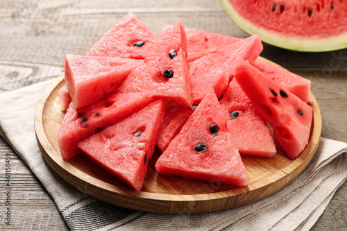 Delicious fresh watermelon slices on wooden table