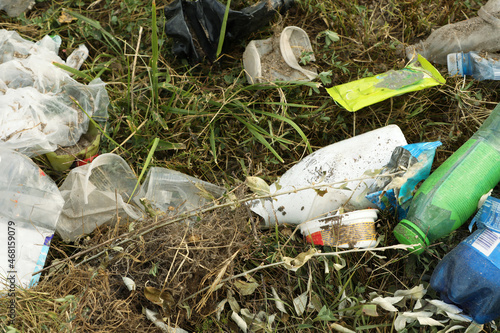 Garbage scattered on grass. Environment pollution problem