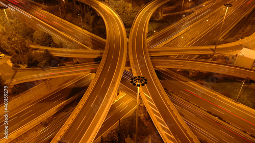 Aerial drone long exposure night photo of urban elevated road junction and interchange overpass in city with light traffic