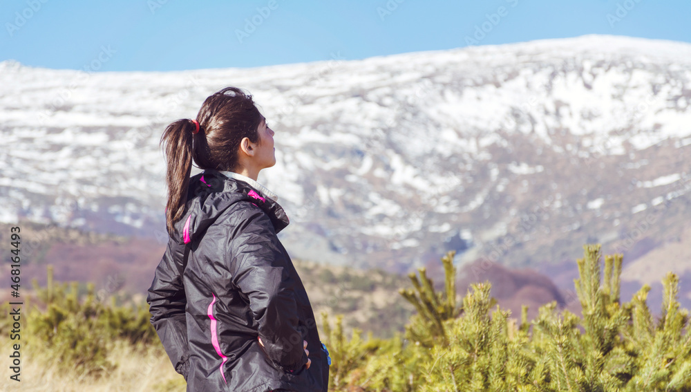 Woman in the High Winter Snowy Mountain .Winter Vacation Concept 