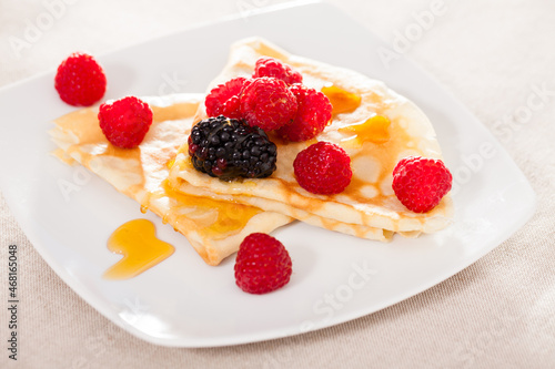 pancakes with raspberries, blackberries and honey