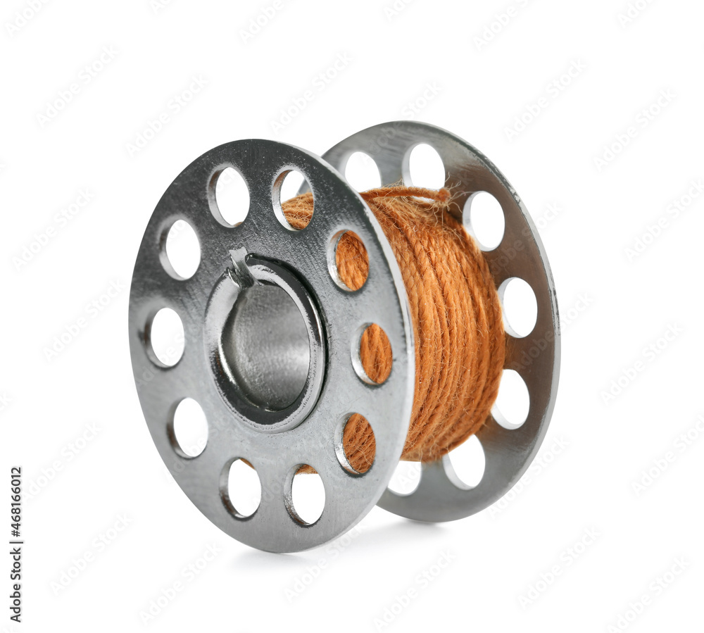 Metal spool of dark orange sewing thread isolated on white Metal spool of dark orange sewing thread isolated on white