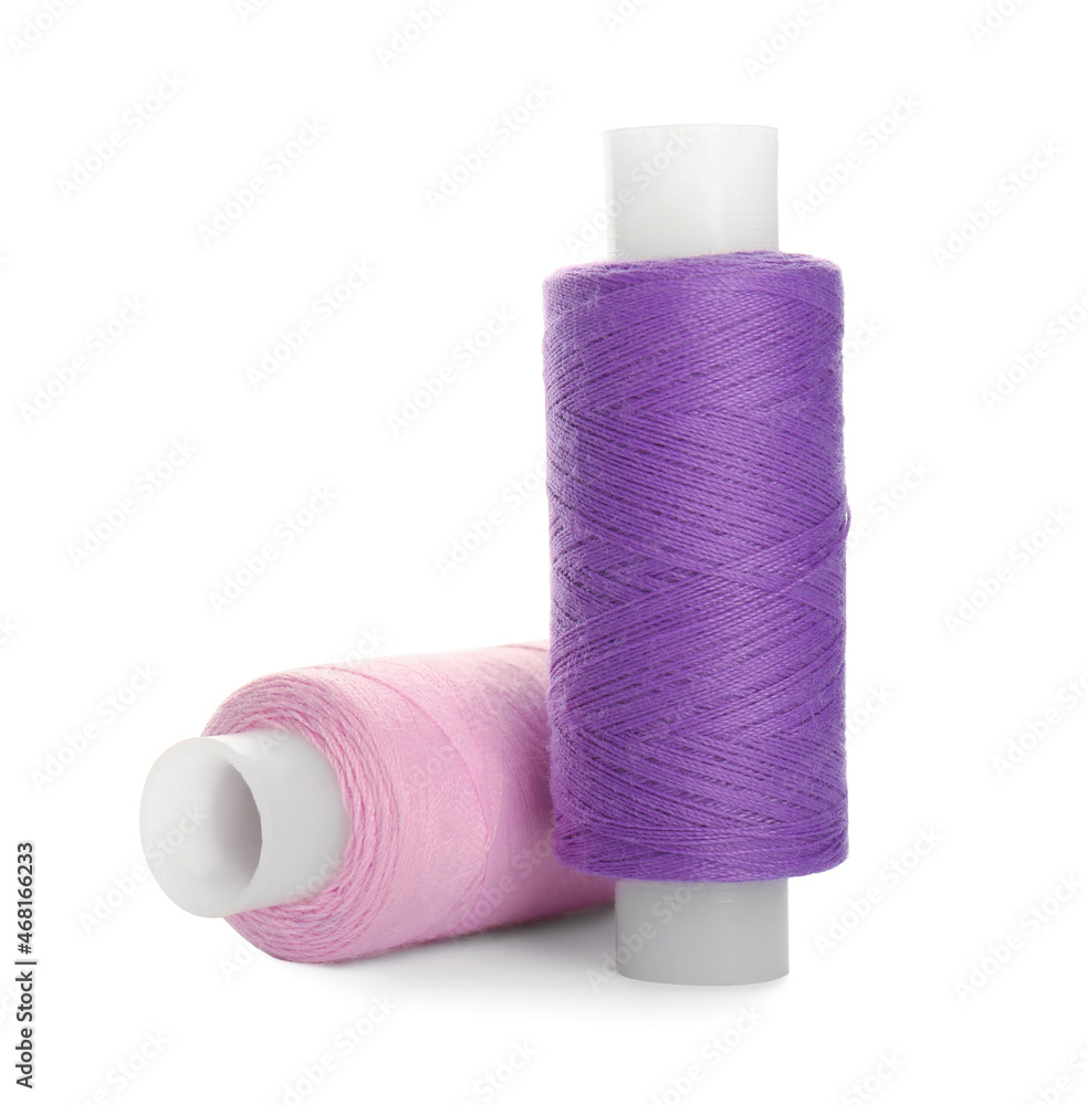 Different colorful sewing threads on white background