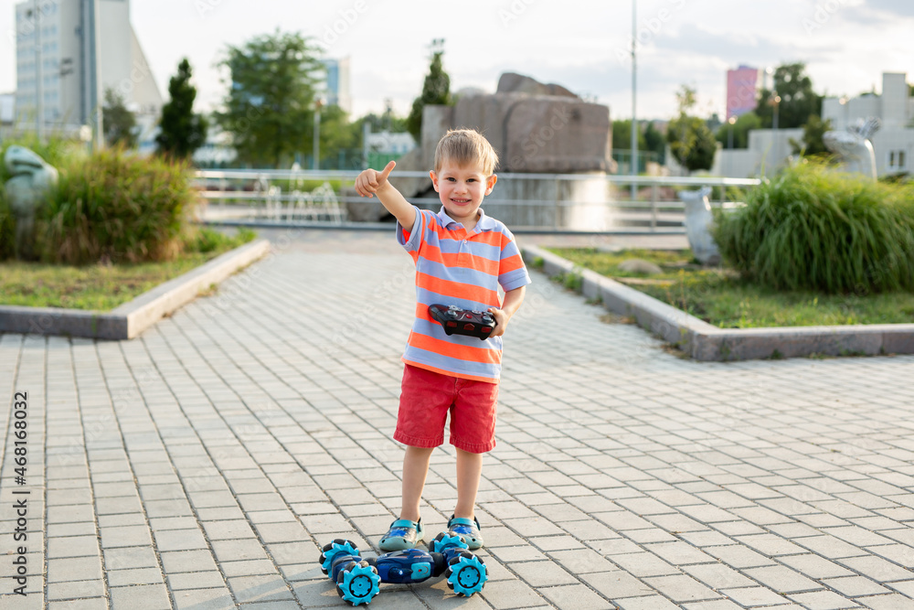 Little boy playing with car on remote control in park Little boy playing with car on remote control in park
