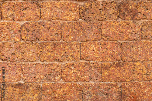 blur of red laterite brick wall Porous and fine-grained Background pattern