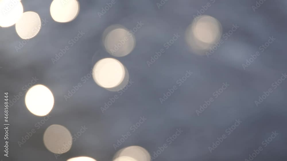 Abstract 4k video bokeh background. Blurry blue water and soft sun lights circles sparkles on wavy rippling liquid backdrop Abstract 4k video bokeh background. Blurry blue water and soft sun lights circles sparkles on wavy rippling liquid backdrop