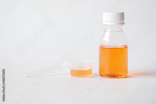 liquid medicine in a container on white background 