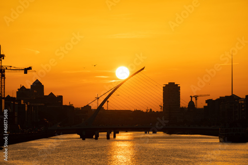 Photography Mesmerizing view of a river at scenic sunset in Samuel Becket bridge, Dublin, Ir