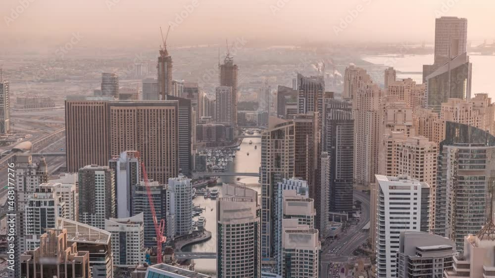 Skyline panoramic view of Dubai Marina showing an artificial canal surrounded by skyscrapers along shoreline timelapse. DUBAI, UAE Skyline panoramic view of Dubai Marina showing an artificial canal surrounded by skyscrapers along shoreline timelapse. DUBAI, UAE