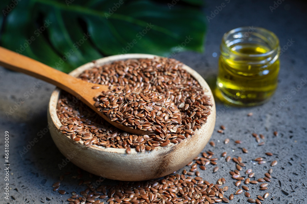 Glass bottle with linseed oil and flax seeds. Glass bottle with linseed oil and flax seeds.