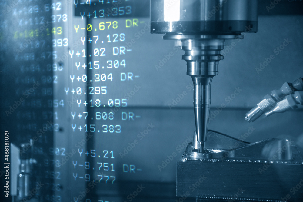 The abstract scene CNC milling machine cutting the stamping die parts and G-code data background. The abstract scene CNC milling machine cutting the stamping die parts and G-code data background.