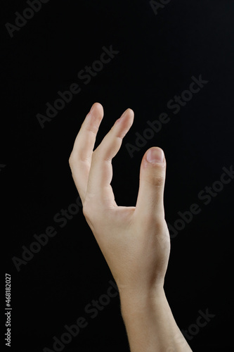 beautiful hand turn on a black background