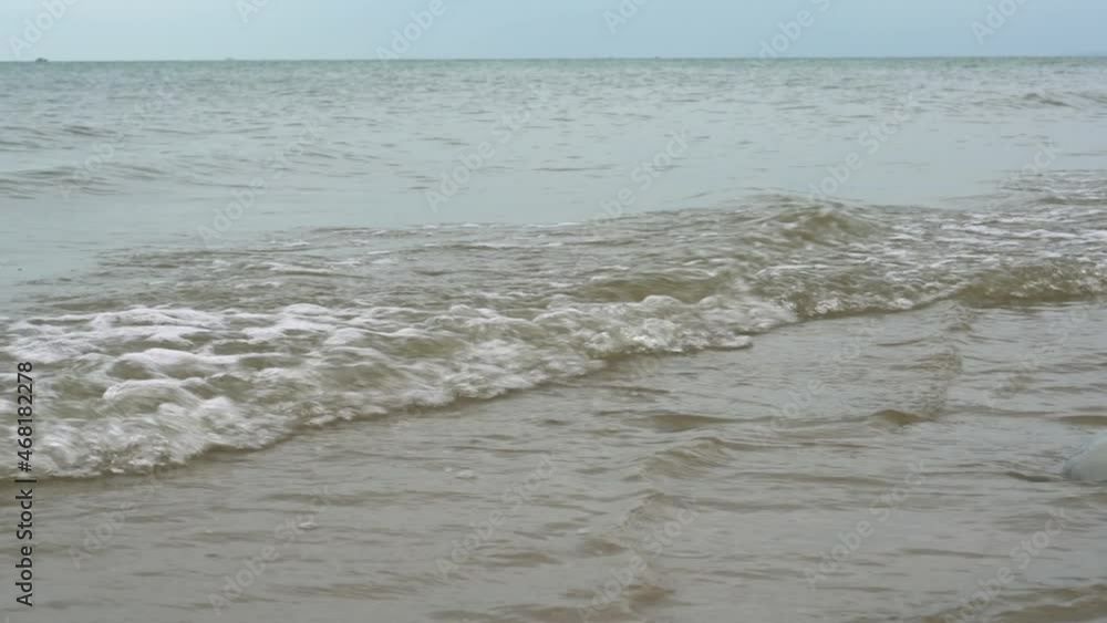 Close-up of the sea waves beating against the shore by the beach Close-up of the sea waves beating against the shore by the beach