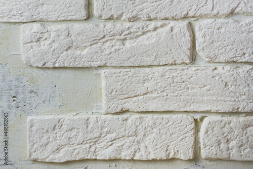 Gypsum white brick wall with cement grout