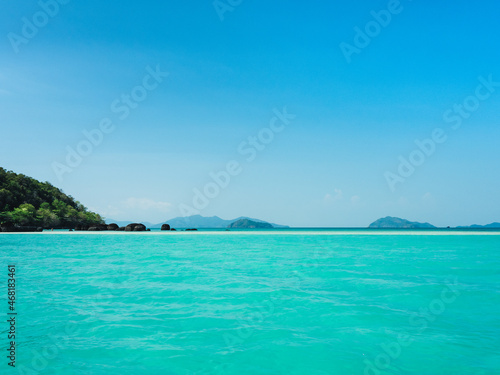 Scenic view of peaceful white sand bar and crystal clear turquoise water against clear blue sky. Koh Kham Island, Near Koh Mak Island, Trat Province, Thailand.