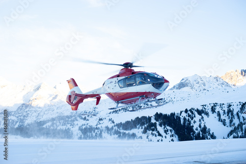 Rescue helicopter lands in the Alps photo