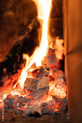 Fire in a hearth with flames surrounding the firewood