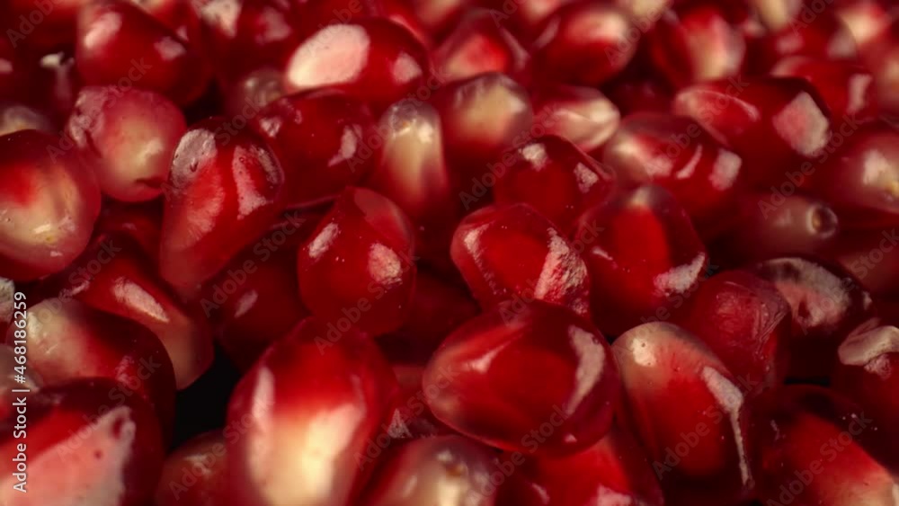 Bright red berries of pomegranate shrub on the dark surface of the table, studio lighting. The use of fruits in raw form. High quality. 4k footage. Bright red berries of pomegranate shrub on the dark surface of the table, studio lighting. The use of fruits in raw form. High quality. 4k footage.