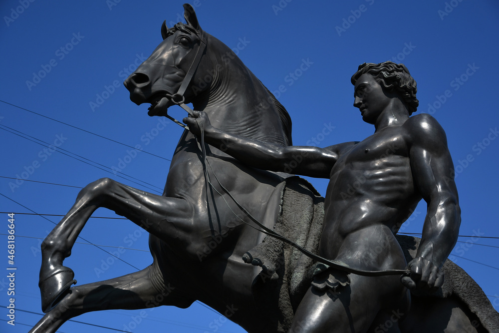 View of Horse tamers monument by Peter Klodt on Anichkov Bridge in Saint-Petersburg Russia. Popular touristic landmark. View of Horse tamers monument by Peter Klodt on Anichkov Bridge in Saint-Petersburg Russia. Popular touristic landmark.