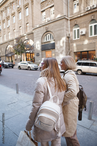 Vertical shot of two women enjoying sightseeing in european city center