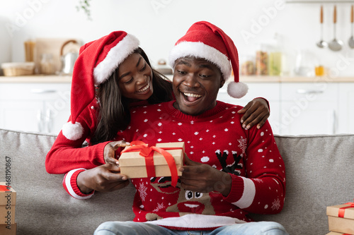 Loving black lady greeting her boyfriend, celebrating Christmas