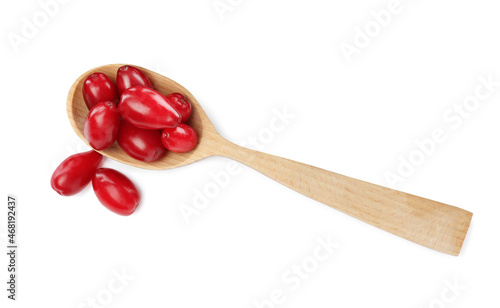 Fresh ripe dogwood berries and wooden spoon on white background, top view