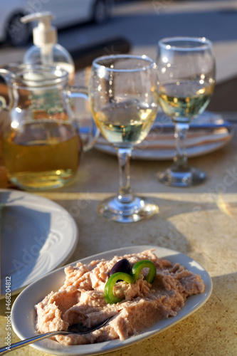 taramasalata dip and white wine on the table in greek tavern photo