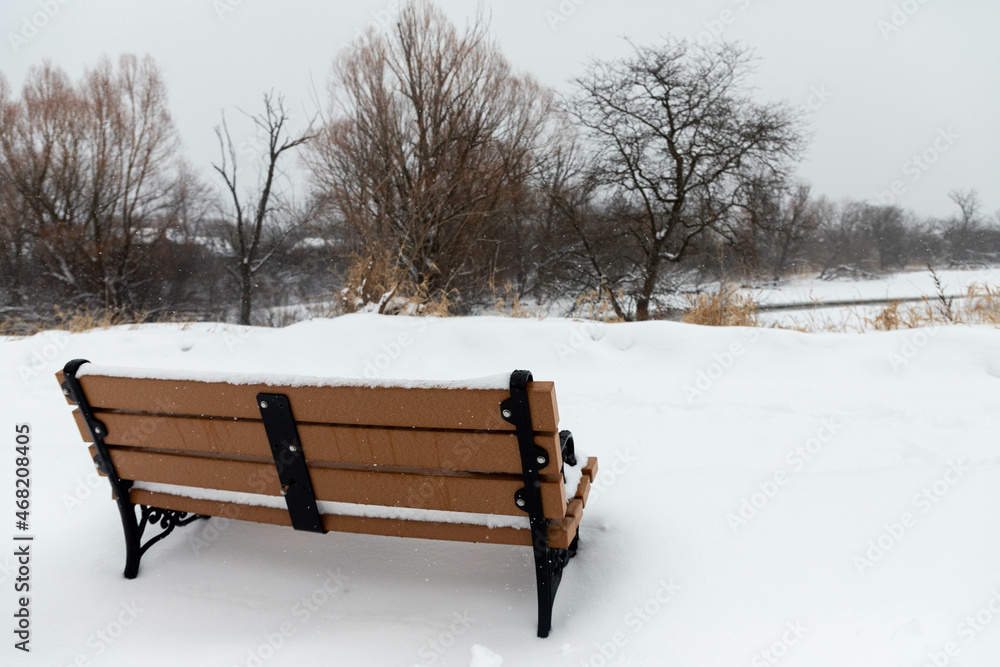 snow-covered bench in the park