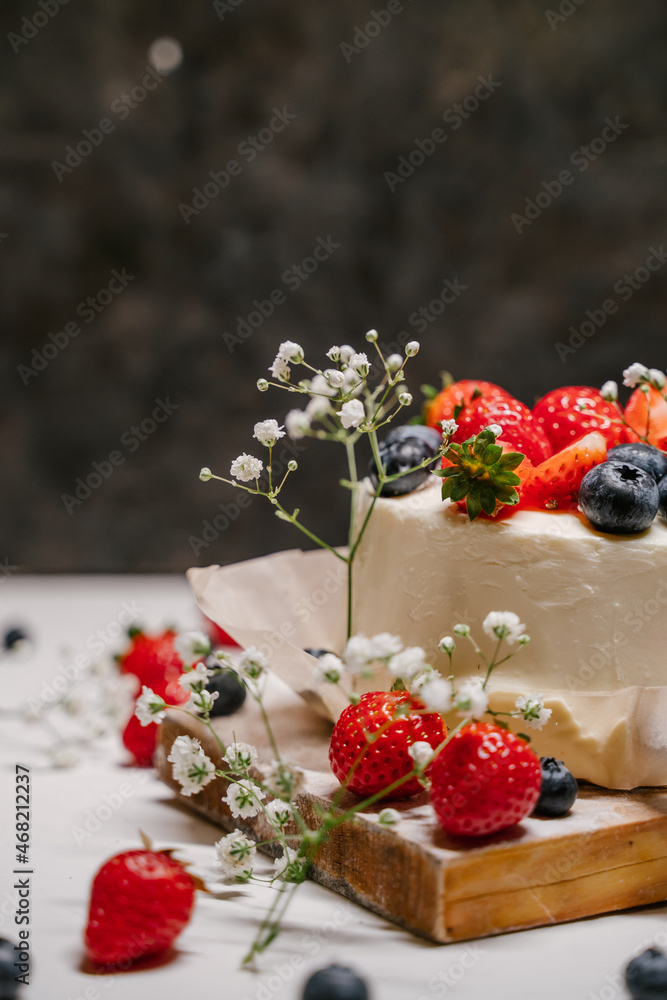 Beautiful strawberry cake decorated with blueberries on a white background