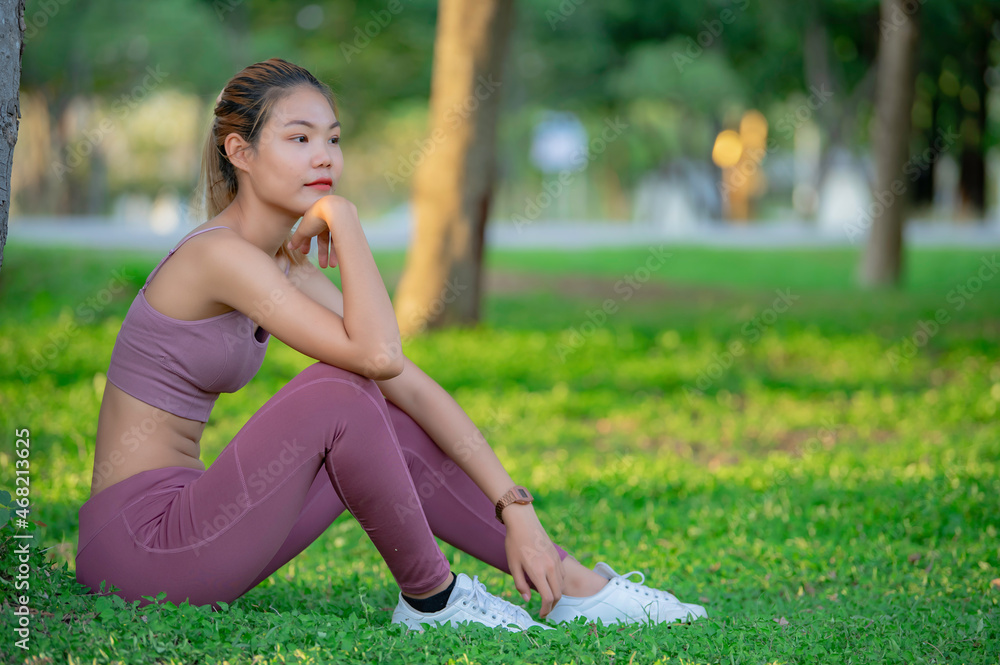 Asian beautiful slim woman at the park,Young girl love healthy exercise,Teen wear sportswear Asian beautiful slim woman at the park,Young girl love healthy exercise,Teen wear sportswear