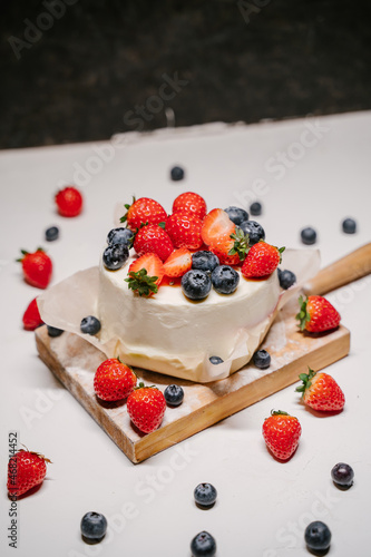 small strawberry bento cake. garnished with strawberries and blueberries