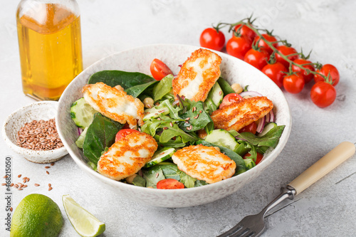 salad with fried halloumi cheese, herbs, cherry, chickpeas, vegan salad