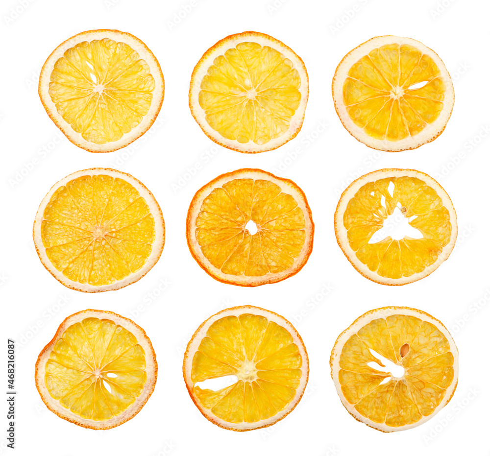 Dried orange slices set on a white background, isolated fruit chips. Top view