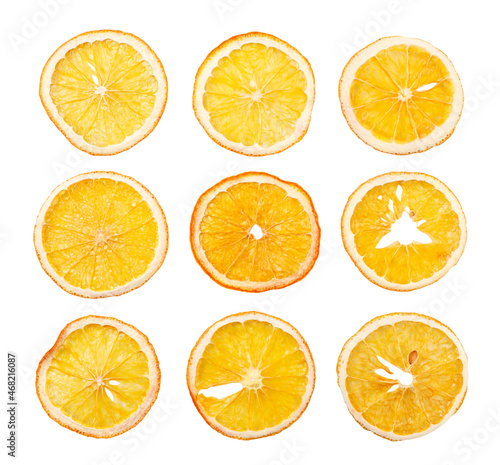 Dried orange slices set on a white background, isolated fruit chips. Top view