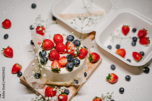 Bento cake with berries in a white package - container